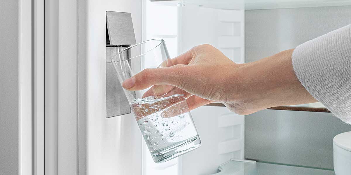 Close-up of the Liebherr InfinitySpring water dispenser inside the fridge