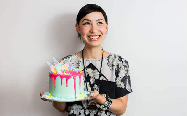 Katherine Sabbath Caption: Katherine Sabbath with one of her colourful cake creations. Image by Daniel Boud
